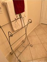Metal towel rack shown alone from an angle to display structure and condition.
