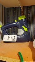 Shark handheld vacuum cleaner placed on a shelf with a tag showing lot number and price