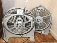 Photo of two fans side by side; front view showing design and condition.