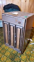 Front and top view of vintage Kenmore Humid Star dehumidifier showing metal body, wood-tone grille, rotary control knob, and indicator light