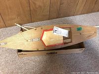 Top-down view showing wooden deck and cabin with beige and red paint.