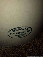 Close-up of the Medalta Potteries Ltd stamp in an oval shape with location 'Medicine Hat Alberta'