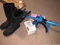 Boots, pedi roller, blood pressure cuff, and two abdominal crunchers arranged on carpet