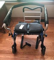 Front view of the Evolution Trillium walker showing padded seats, hand grips, and wheels