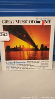 Front cover of the new sealed Leonard Bernstein vinyl record album titled Great Music Of Our Time. Shows sunset cityscape image with a bridge and album title.