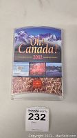 Front view of plastic display case for 2002 Oh! Canada! uncirculated coin set with Canadian scenic images.