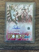 Front of Panini NBA Hoops basketball trading card featuring Tony Delk with autograph in blue ink on artistic background.