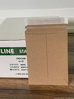 Open kraft self-sealing mailer displaying flap and flat shape