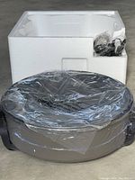 Curtis Stone Durra electric skillet unit sealed in plastic with styrofoam packaging behind it