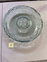 Top-down view of a clear glass blown dip bowl showing textured edges and interior center dip compartment.
