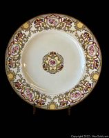 Front view of one Morgan Belleek China dinner plate showing floral and gold patterned rim with central floral medallion.