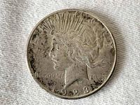 Obverse side of the 1923 S Peace Dollar showing Lady Liberty profile, date, and some tarnishing and wear.