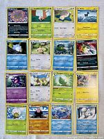 Top view of 16 assorted Pokémon cards laid out showing various Basic and Stage 1 Pokémon