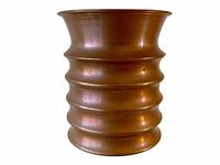 Front and side view of the copper vase showing the barrel shape and horizontal groove rings