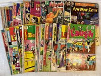 31 Various Vintage Comics fanned out showing front covers with various titles and colorful illustrations.