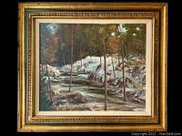 Front view of framed oil painting showing forest stream scene