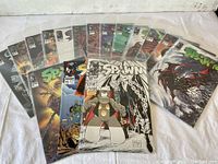 Layout of all 16 Spawn comic book issues, showing various covers in color and black & white, arranged horizontally and vertically.