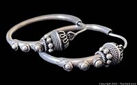 Close-up shot of the detailed sterling silver Bohemian hoop earrings showing decorative spherical beads and ribbed accents