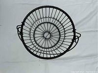 Top view of the circular metal egg basket showing concentric metal wire construction and coiled wire reinforcement.