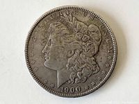 Obverse side of the 1900 Morgan silver dollar showing the Liberty head with date and surrounding stars and inscriptions.