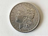 Obverse side of the 1900 Morgan silver dollar showing Liberty's profile and date.
