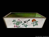 Front view of rectangular cloisonné planter showing pomegranate, bird, and floral motifs on cream background with green interior.