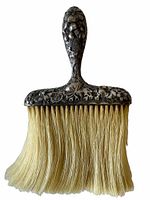 Close-up front view of the crumb brush showing detailed floral silver handle and natural bristles, isolated on white background.