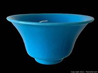 Blue Peking Glass Bowl shown against black background, displaying the flared shape and vibrant blue color.