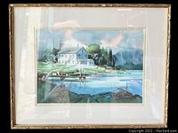 Framed watercolor painting showing a dock scene with houses, trees, and water in Essex, Massachusetts.