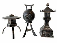 Front view of three Japanese sterling silver salt shakers showing unique lantern-shaped novelty designs with patinated silver finish.