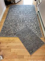 Full top view of the two rugs on hardwood floor, showing the larger and smaller Loloi II Lucia rugs