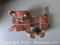 Red Columbian bench vise with 3 inch jaws, showing wear from use.