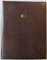 Brown leather portfolio binder believed to be by Fleetwood, housing the collection of First Day Covers.