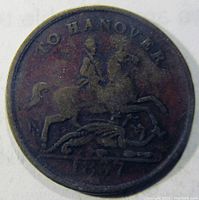Reverse side of the copper token showing horseman slaying dragon with inscription and date.
