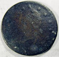Front side of heavily worn 1863 Army and Navy Civil War token showing corroded surface with indistinguishable imagery.