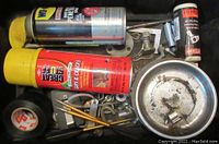 Top view showing WD-40, Great Stuff, magnetic parts tray with hardware, hand tools, and a red spray can
