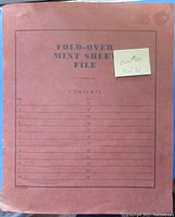 Front cover of fold-over mint sheet file showing contents index and note about over $80 face value of stamps inside.