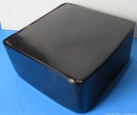 Closed view of the vintage faux tortoise shell rectangular box showing dark brown finish with subtle mottled amber patterns and smooth edges.