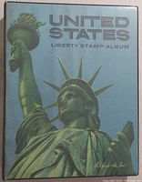 Blue hardcover United States Liberty Stamp Album with Statue of Liberty image on cover