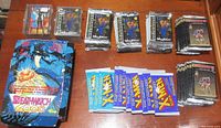 Multiple stacks of sealed trading card packs from 1993 Ultraverse by Skybox, 1992 Marvel Uncanny X-Men, and 1993 Upper Deck The Valiant Era, along with Sachs and Violens card set in protective cases.