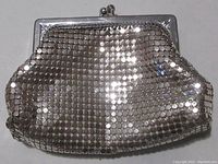 Front view of silver metal mesh change purse showing clasp and mesh texture.
