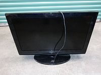 Front view of 32 inch Samsung flat screen TV, black bezel and stand visible.