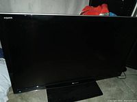 Front view of the Sharp Aquos flat screen TV showing the screen and part of the stand