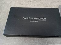 Black closed storage box with Pimsleur Approach Edición Gold label