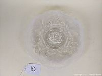 Top view of the Fenton opalescent glass plate showing the water lilies and cattails embossed pattern with scalloped edges