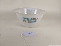 Front view of Blue Heaven mixing bowl displaying geometric blue and brown pattern on white glass.