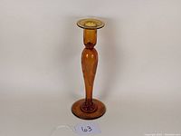 Front view of amber glass candlestick showing full height and shape