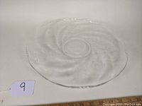 Clear 14-inch torte plate with Orchid pattern on flat surface and scalloped edges.