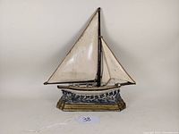 Front view of the painted cast iron sailboat doorstop