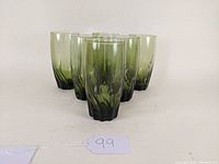 Front view of six green-tinted Anchor Hocking highball tumblers with ivy pattern arranged in a cluster.